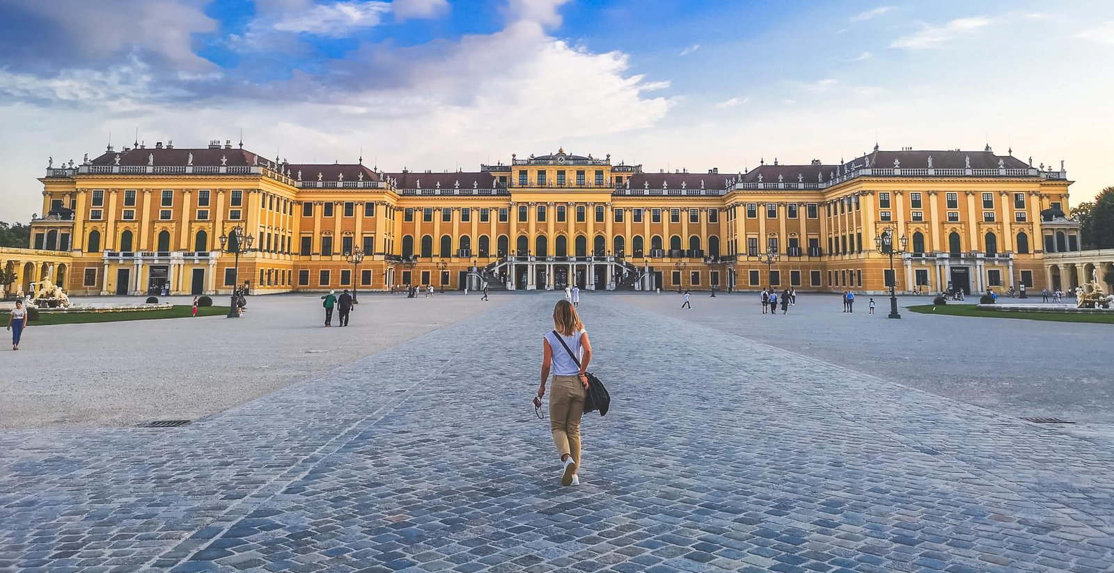 A woman walking in front of Schönbrunn Palace, Vienna