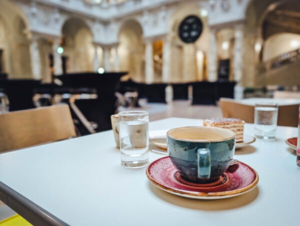 Café table in Weltmuseum hall — free to enter.