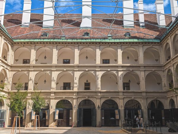 Empty Renaissance arcaded courtyard of the Stallburg at Hofburg under a clear sky